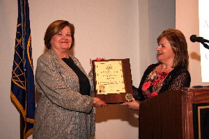 Skinner (r) presents a lifetime membership plaque to Lorna Estep, chair of the chapter's board of directors, in July. 